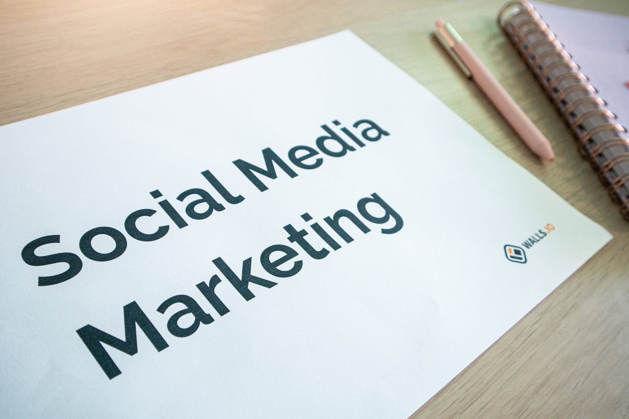 home-services-004 Close-up of a social media marketing document on a desk with a pen and notebook.