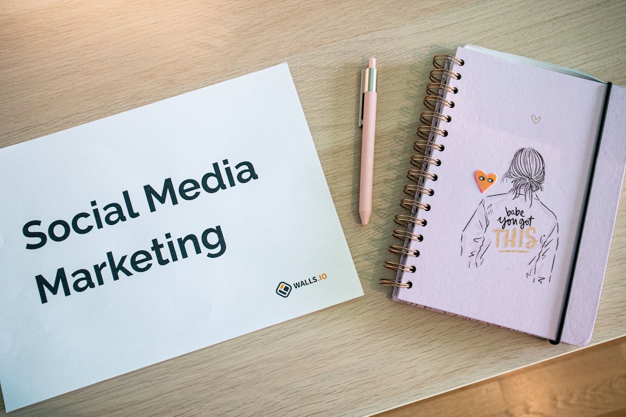 home-services-03 Flat lay of social media marketing paper and motivational notebook on wooden desk.